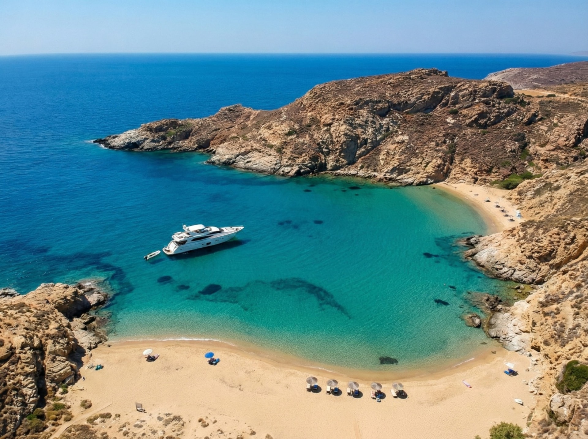 Luxury yacht anchored in a beautiful cove with crystal clear turquoise waters in Greece